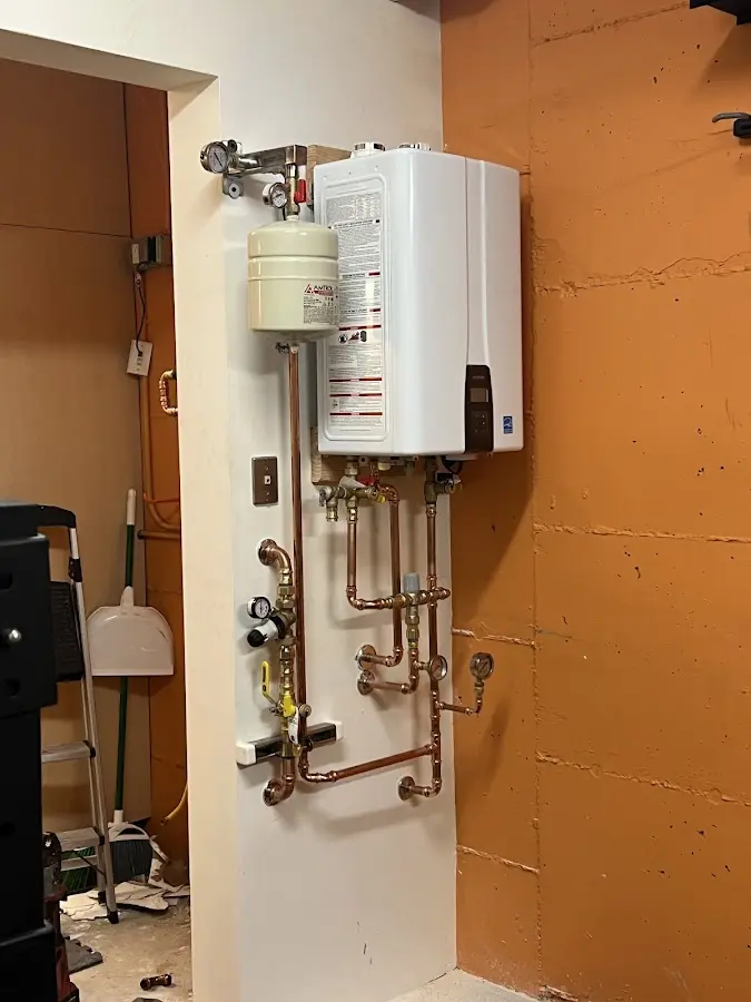 Plumbing technician inspecting water heater connections in Flagler Estates